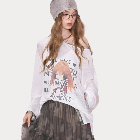 Person wearing a white oversized shirt with graphics and text, standing against a plain background.